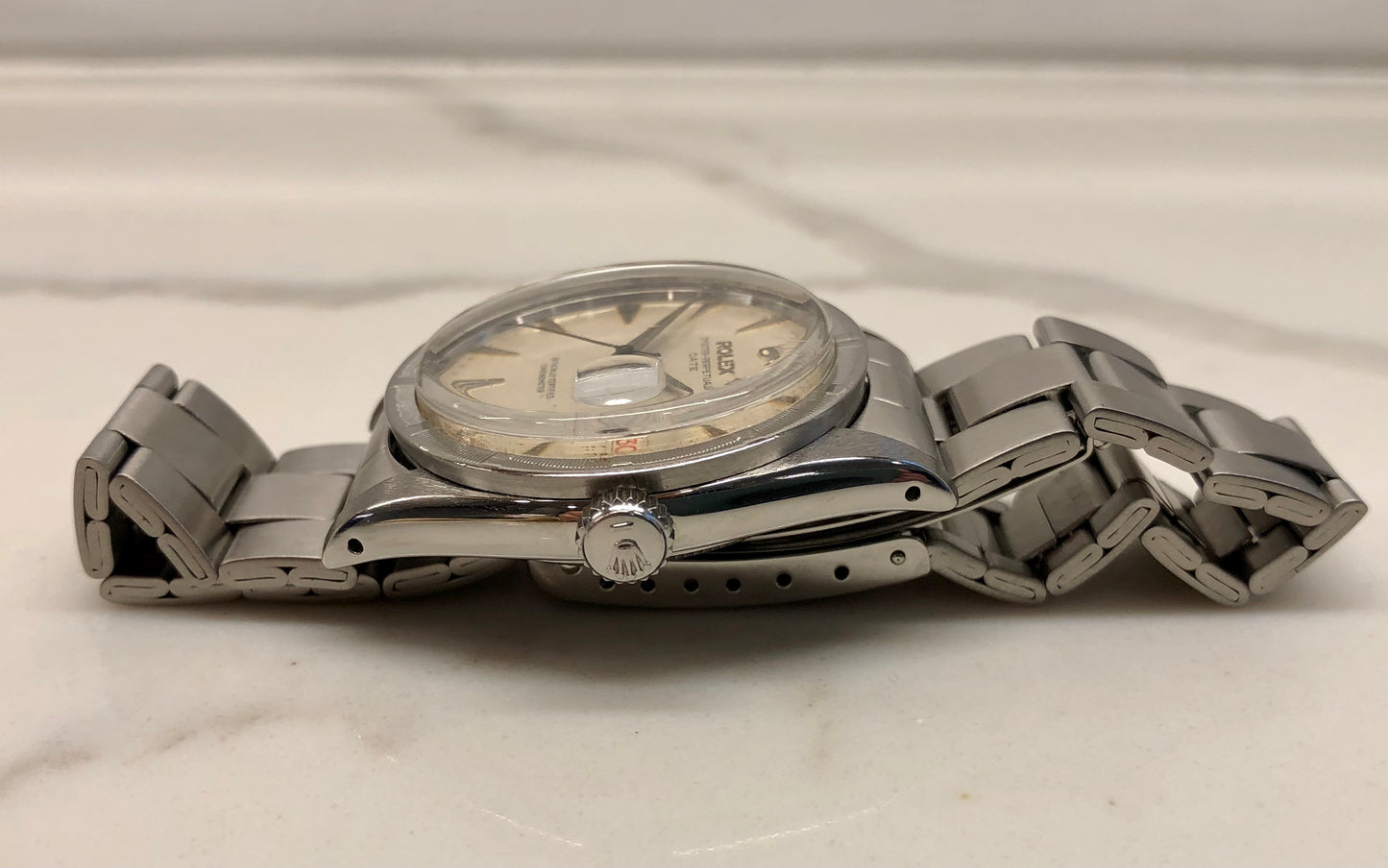 1958 Rolex Date 6535 Steel Engine Turned Oyster Roulette Wheel Automatic Wristwatch