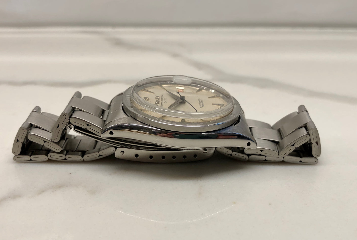 1958 Rolex Date 6535 Steel Engine Turned Oyster Roulette Wheel Automatic Wristwatch